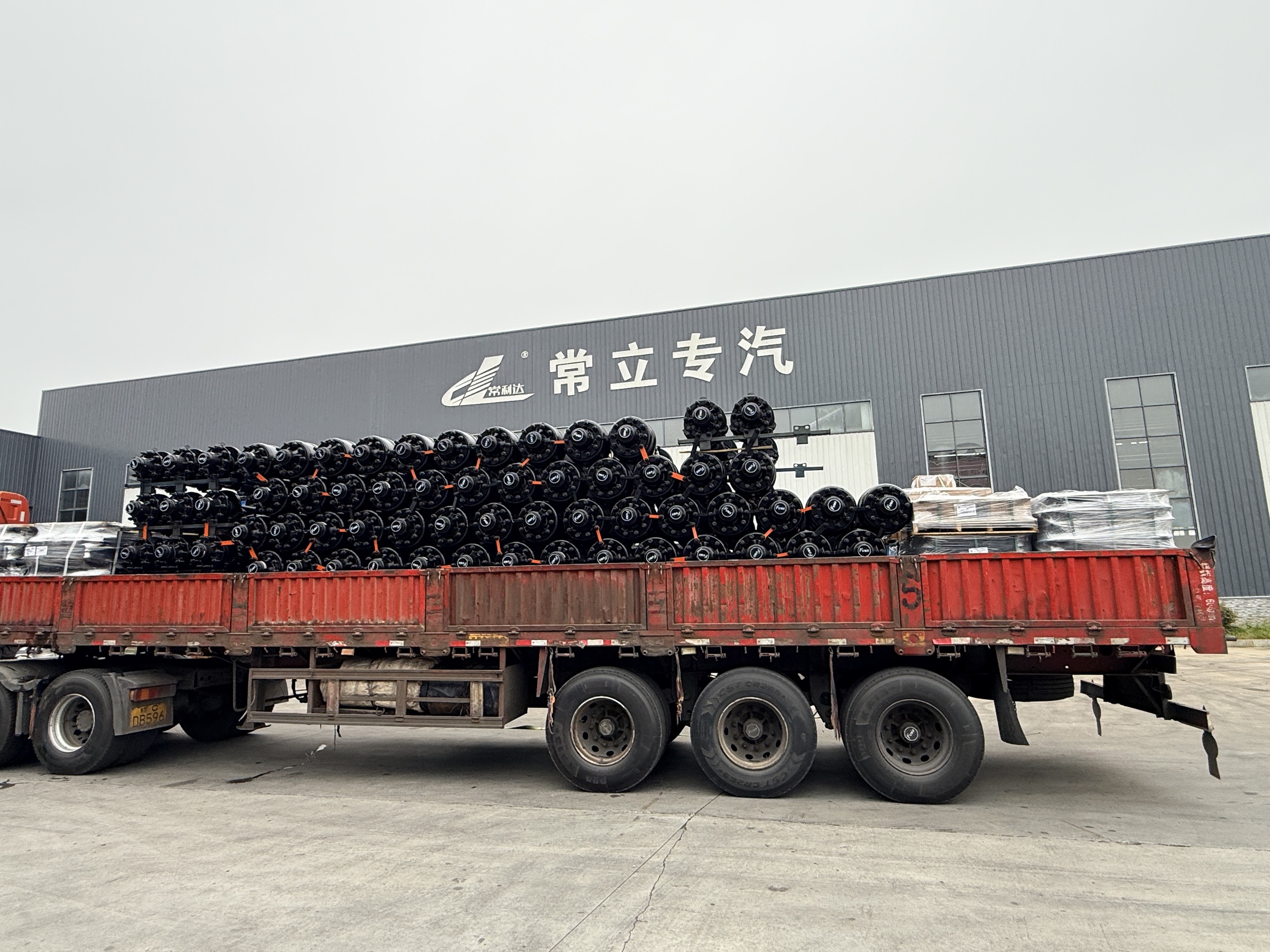 FUWA axle assemblies loaded for dispatch outside a manufacturing facility